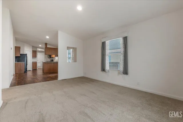 a view of a kitchen with a sink and a refrigerator