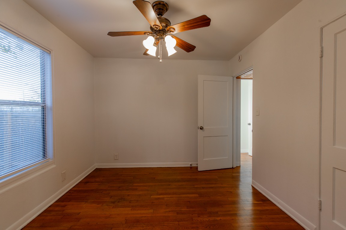 5515 Roosevelt Avenue Austin, TX 78756 - Photo 14 of 17 wooden floor in an empty room with a window