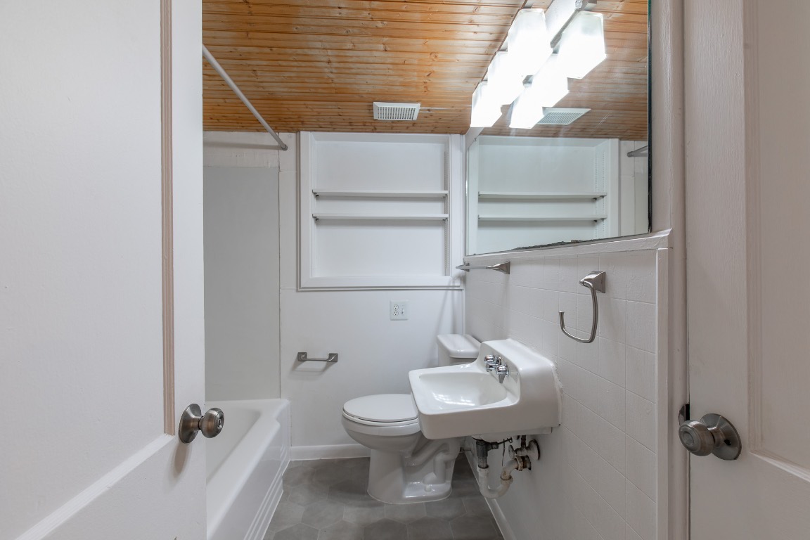 5515 Roosevelt Avenue Austin, TX 78756 - Photo 16 of 17 a bathroom with a sink a toilet and shower