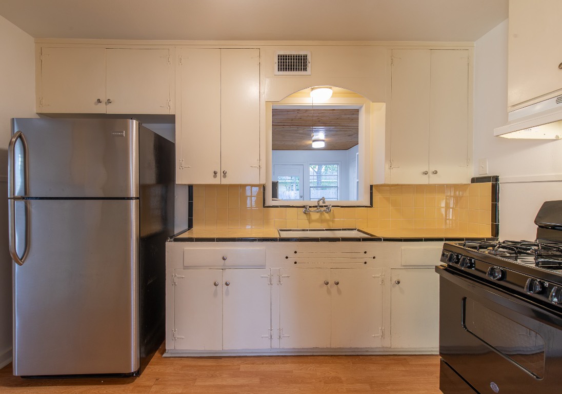 5515 Roosevelt Avenue Austin, TX 78756 - Photo 5 of 17 a kitchen with a refrigerator and a stove