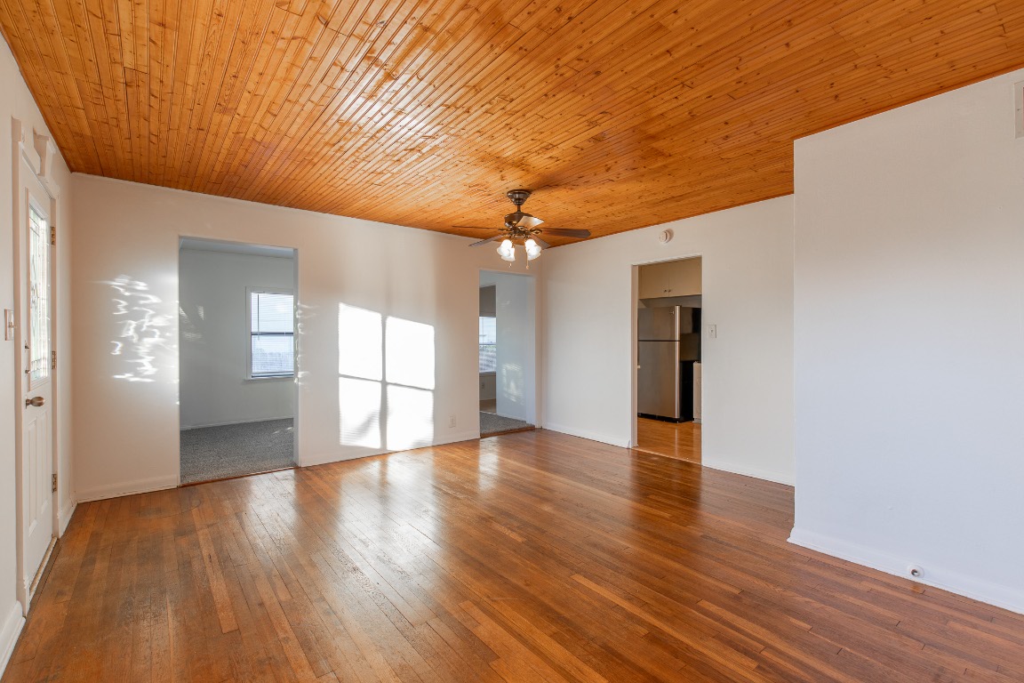 5515 Roosevelt Avenue Austin, TX 78756 - Photo 7 of 17 a view of an empty room with wooden floor and a window