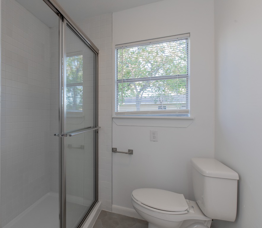 5515 Roosevelt Avenue Austin, TX 78756 - Photo 9 of 17 a white toilet sitting next to a window in a bathroom