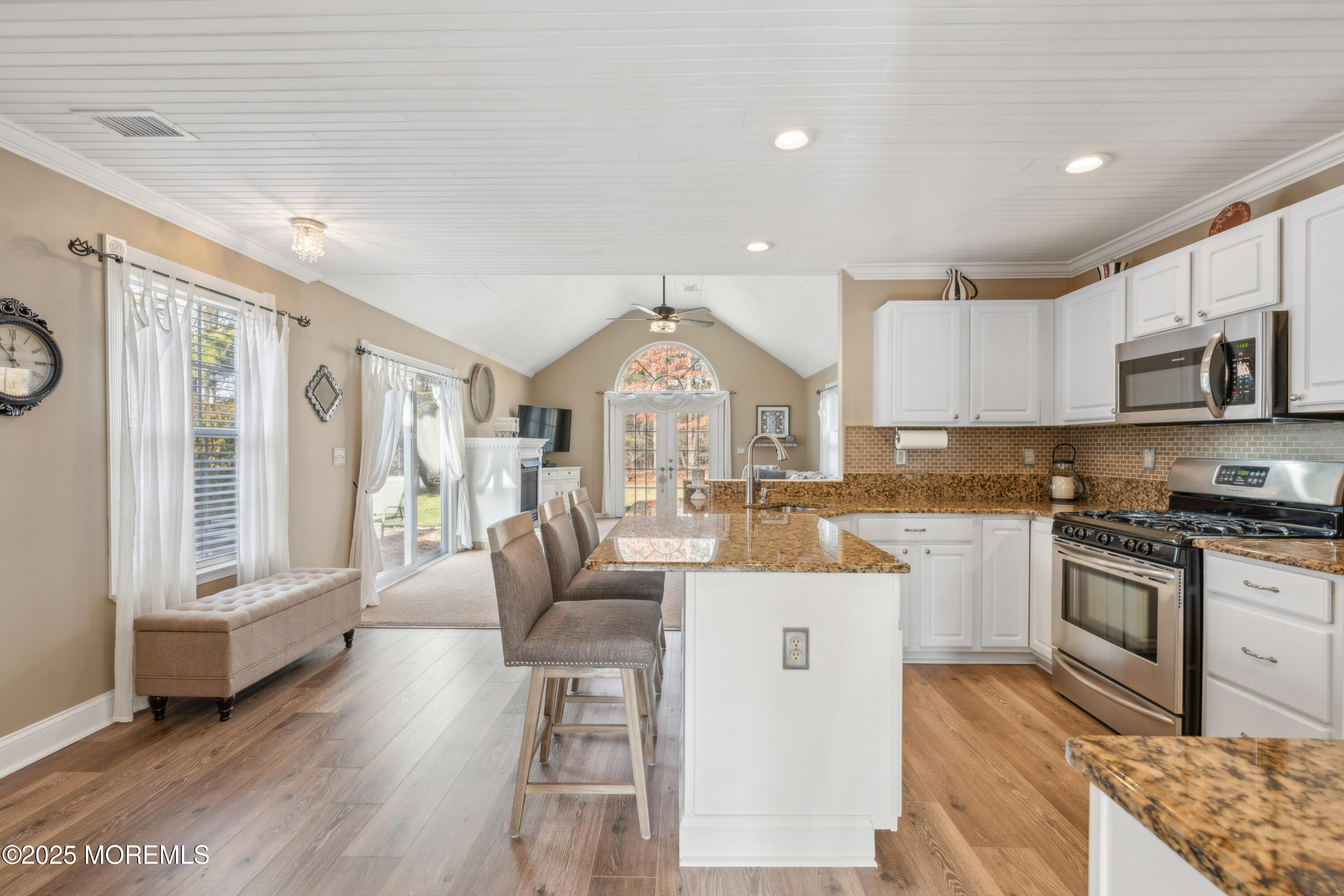 20 Capitol Reef Road Howell, NJ 07731 - Photo 14 of 38 a open kitchen with granite countertop a stove top oven a sink a dining table and chairs