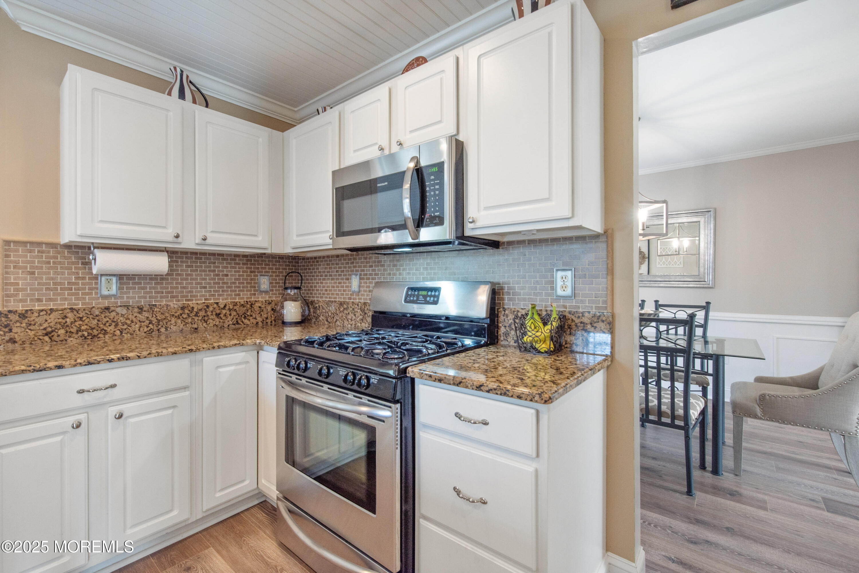 20 Capitol Reef Road Howell, NJ 07731 - Photo 15 of 38 a kitchen with granite countertop white cabinets and white appliances