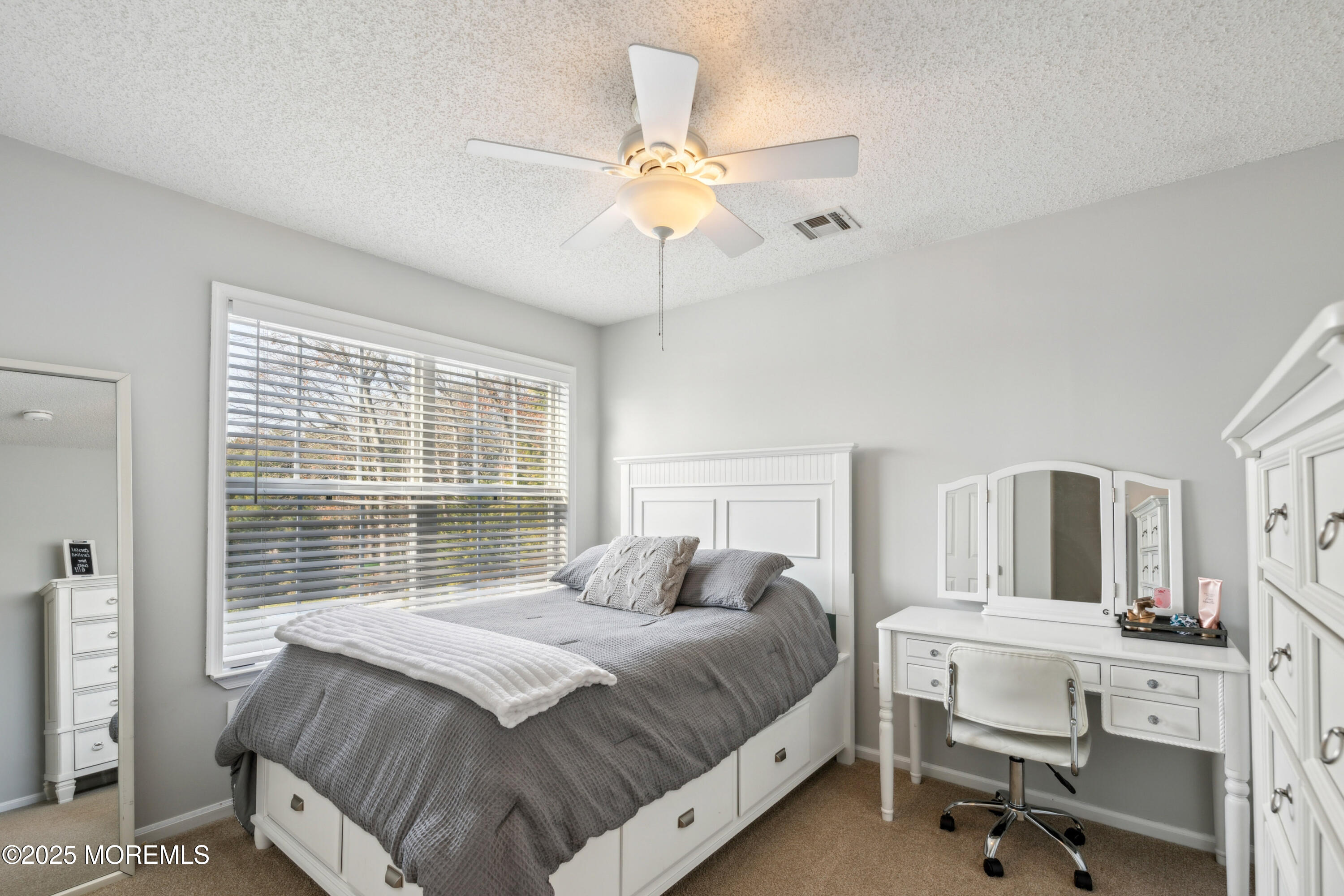 20 Capitol Reef Road Howell, NJ 07731 - Photo 30 of 38 a bedroom with a large bed and a chandelier