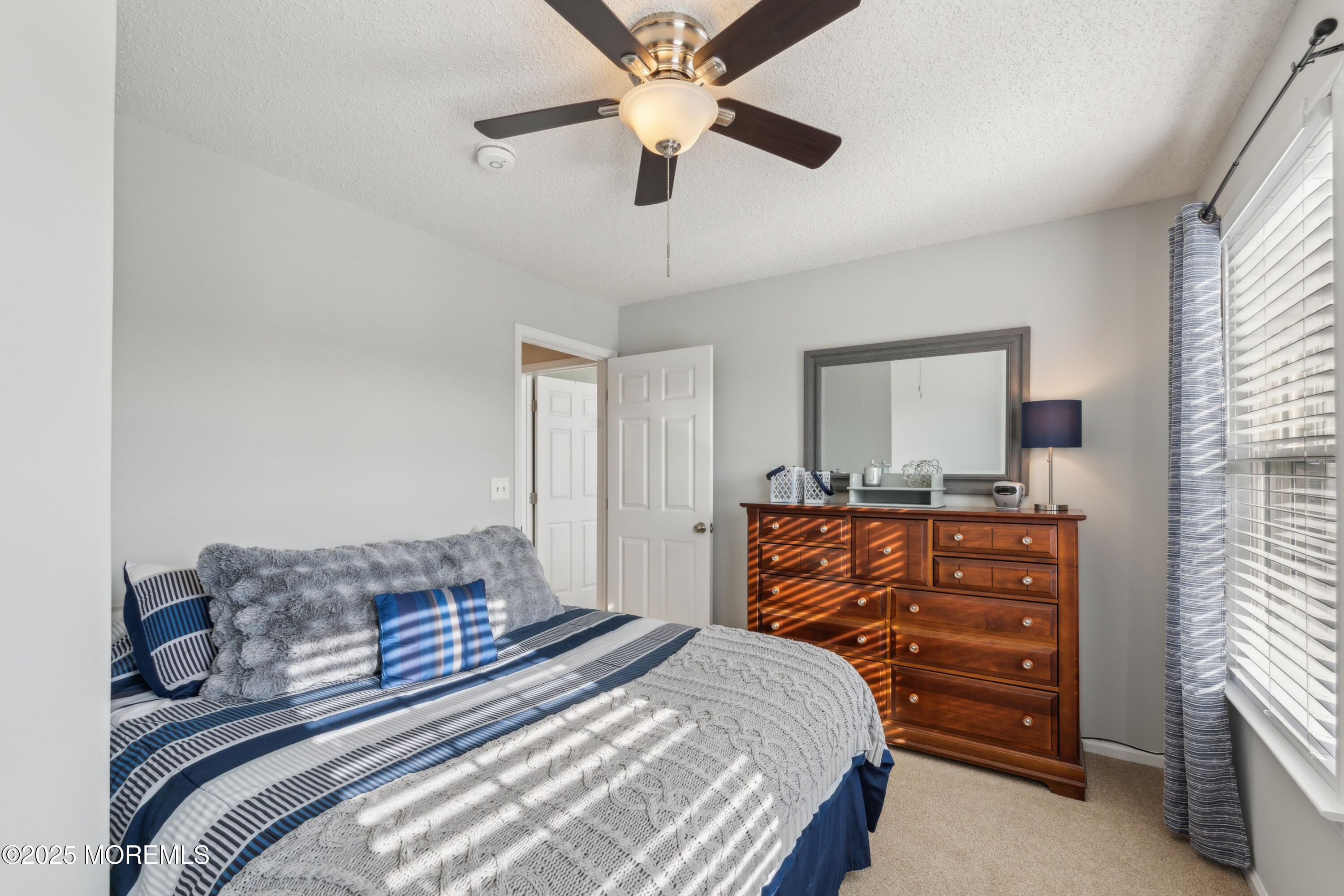 20 Capitol Reef Road Howell, NJ 07731 - Photo 32 of 38 a bedroom with a bed and a chandelier