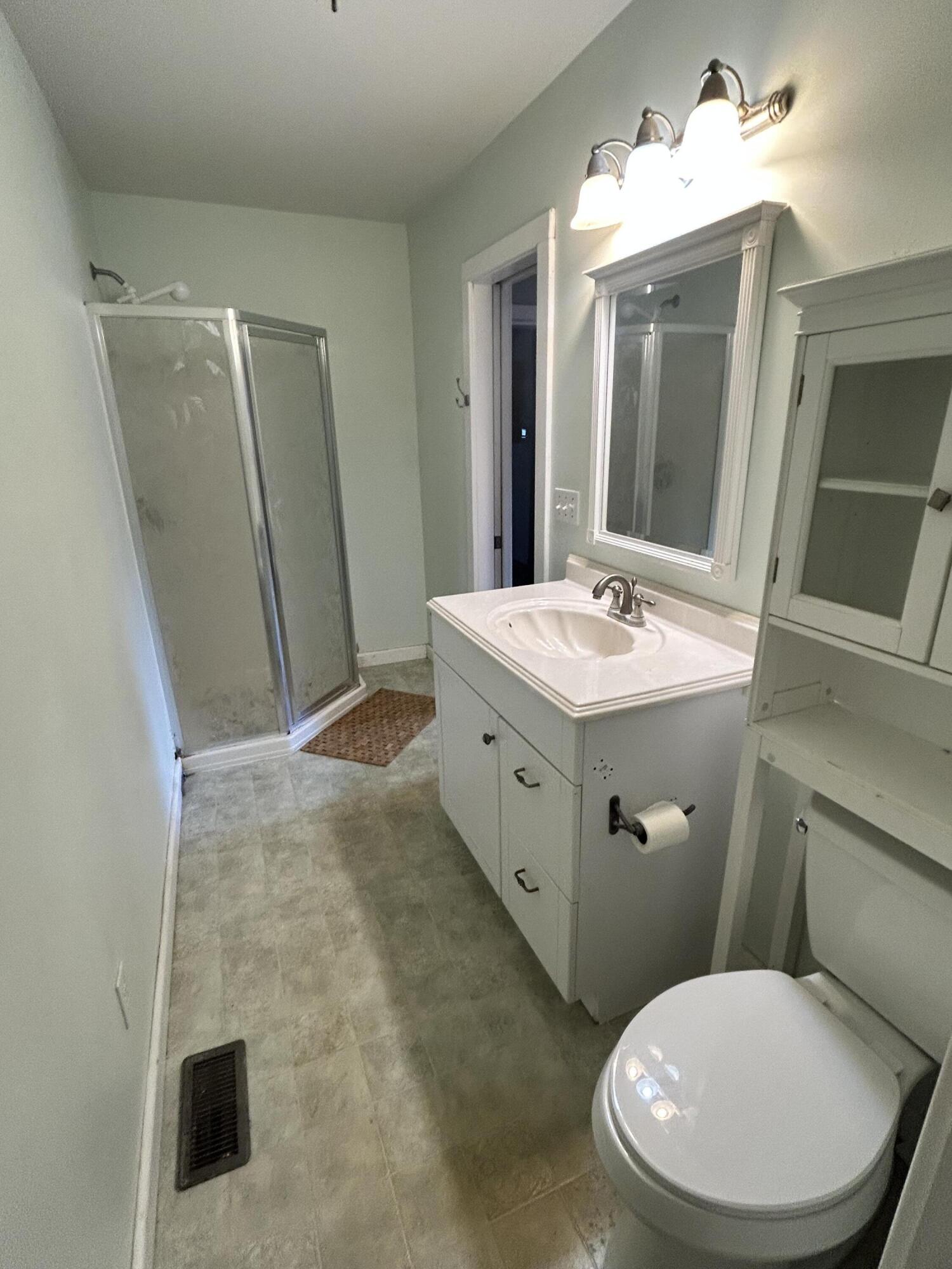 708 South Main Street Kouts, IN 46347 - Photo 8 of 22 a bathroom with a toilet sink and mirror