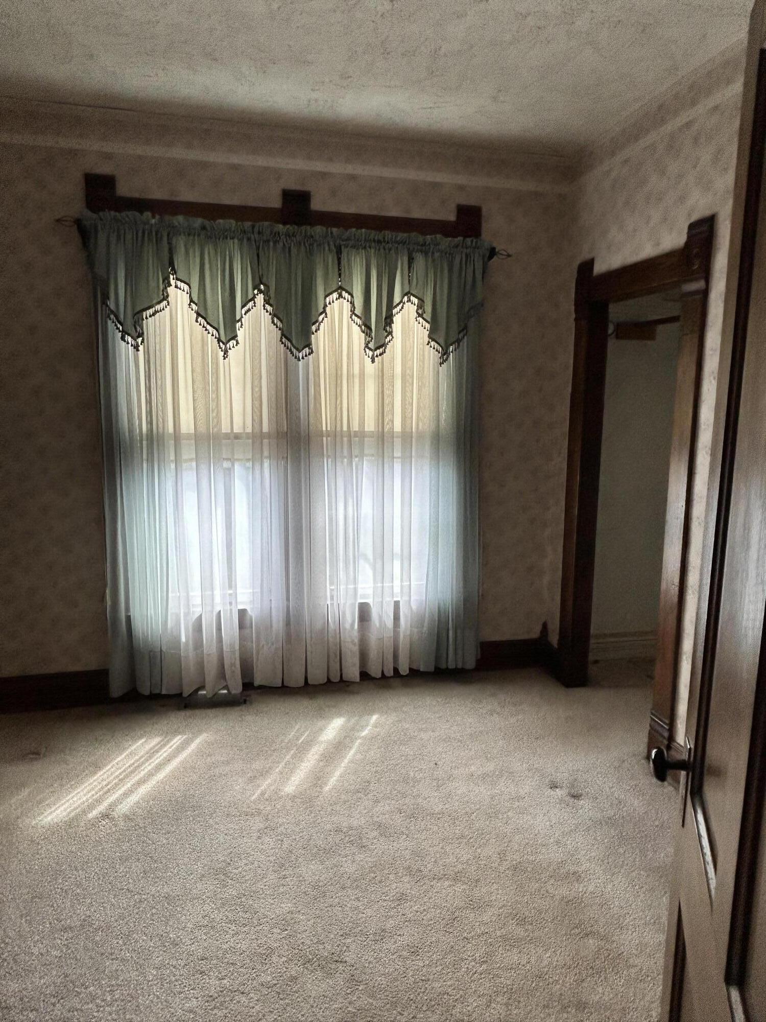 708 South Main Street Kouts, IN 46347 - Photo 10 of 22 an empty room with a window