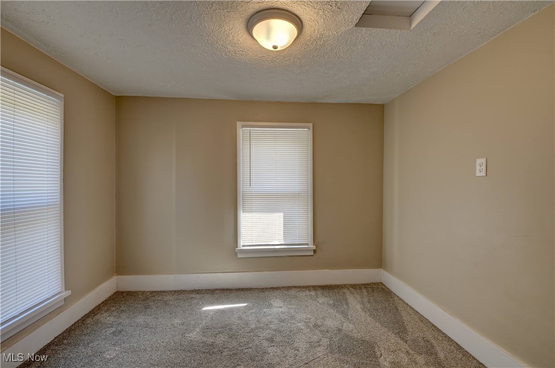 4624 Ridge Avenue Southeast Canton, OH 44707 - Photo 38 of 48 Carpeted spare room with a textured ceiling and healthy amount of natural light