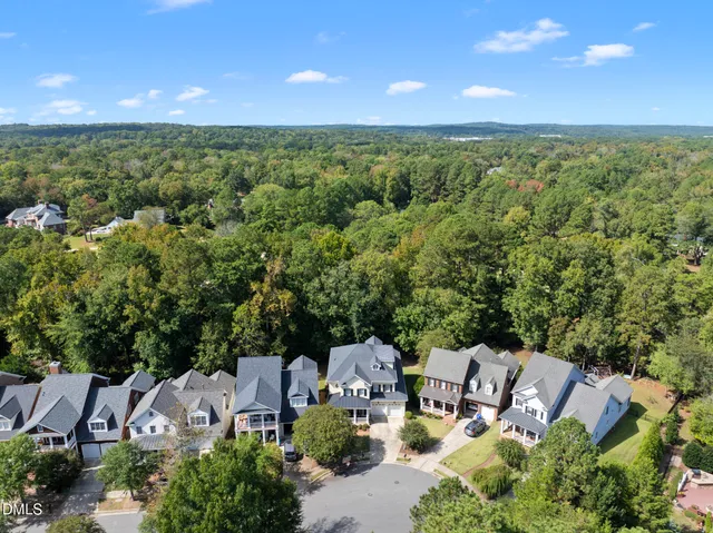 a view of a hallway with wooden floor and a rug