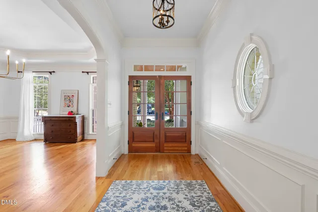 a living room with furniture a fireplace and a floor to ceiling window