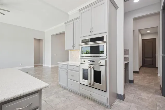 a kitchen with stainless steel appliances white cabinets and a stove