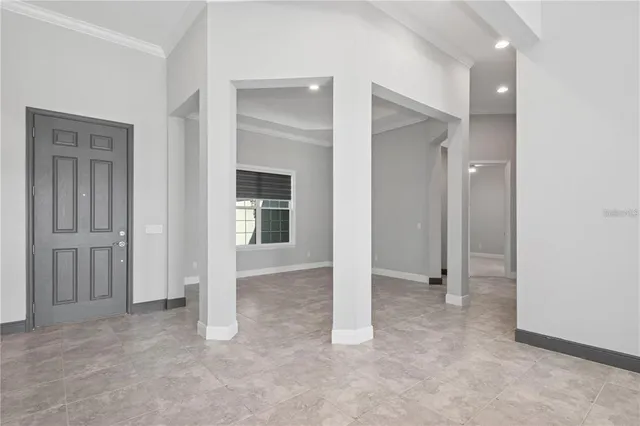 an empty room with closet and a bathroom