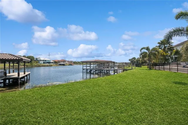 a view of a lake with houses in the back