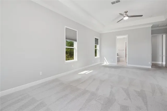 a view of a livingroom with a ceiling fan and window