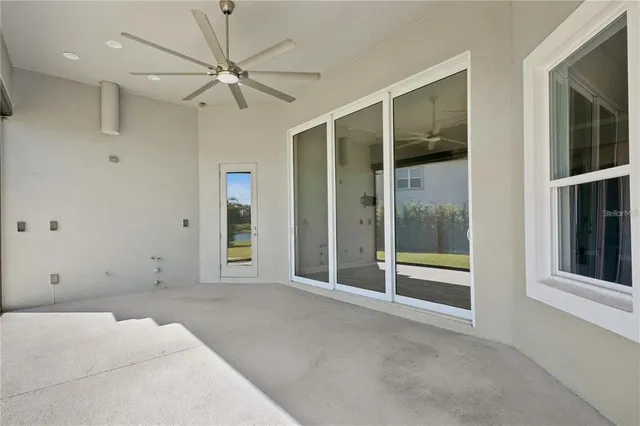 a kitchen with a refrigerator and white cabinets