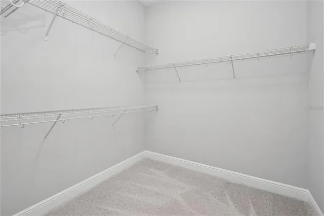 a front view of a house with a garden and yard