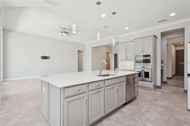 a kitchen with a sink counter top space appliances and cabinets