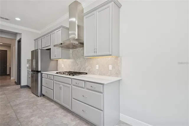 a kitchen with cabinets and stainless steel appliances