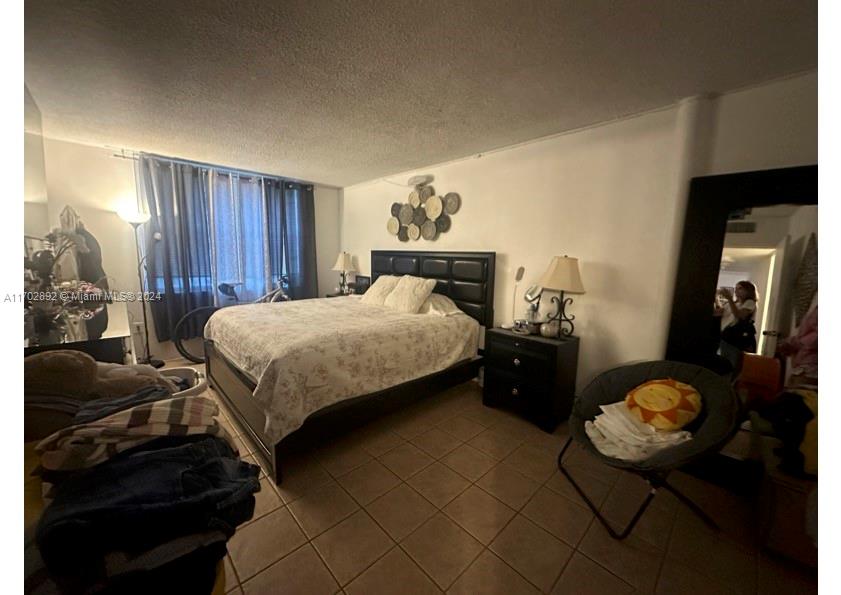 1800 Sans Souci Boulevard, Unit 239 North Miami, FL 33181 - Photo 12 of 15 a bedroom with a bed and dresser