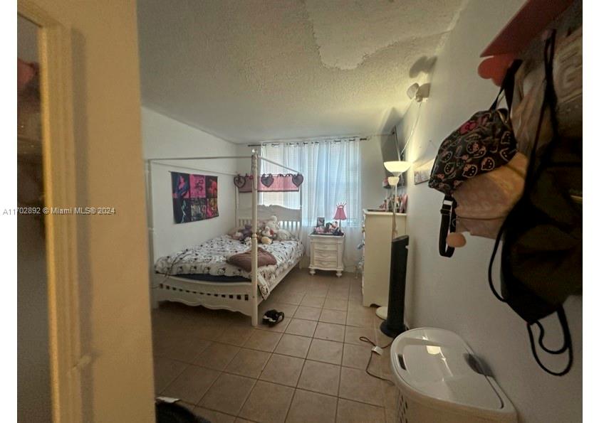 1800 Sans Souci Boulevard, Unit 239 North Miami, FL 33181 - Photo 13 of 15 a room with furniture and a window