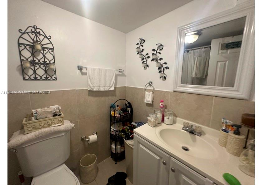 1800 Sans Souci Boulevard, Unit 239 North Miami, FL 33181 - Photo 15 of 15 a bathroom with a sink mirror and toilet