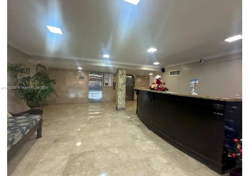 1800 Sans Souci Boulevard, Unit 239 North Miami, FL 33181 - Photo 2 of 15 a view of a hallway with a projector