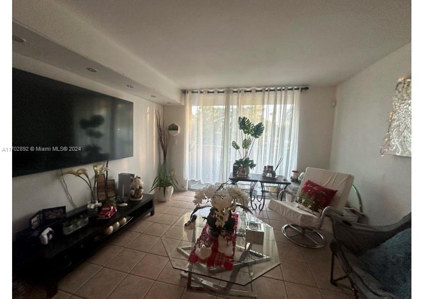 1800 Sans Souci Boulevard, Unit 239 North Miami, FL 33181 - Photo 4 of 15 a living room with furniture and a flat screen tv