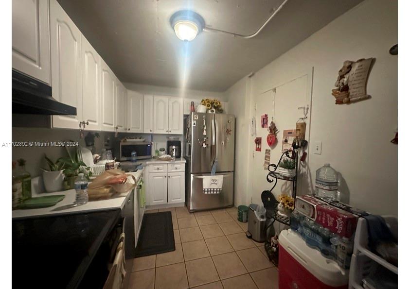 1800 Sans Souci Boulevard, Unit 239 North Miami, FL 33181 - Photo 8 of 15 a kitchen with refrigerator and cabinets
