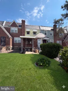 a front view of a house with a yard table and chairs