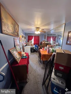 a living room with furniture a flat screen tv and a dining table