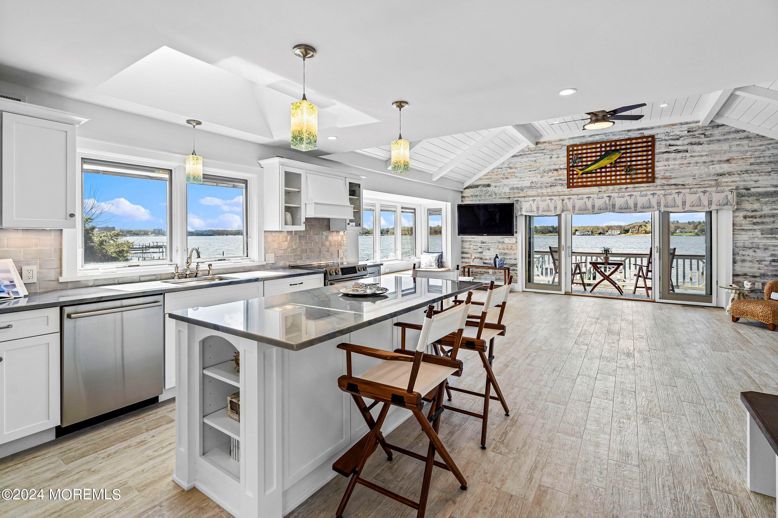 30 Alston Court Red Bank, NJ 07701 - Photo 75 of 103 a kitchen with stainless steel appliances kitchen island granite countertop a table chairs in it and a wooden floors