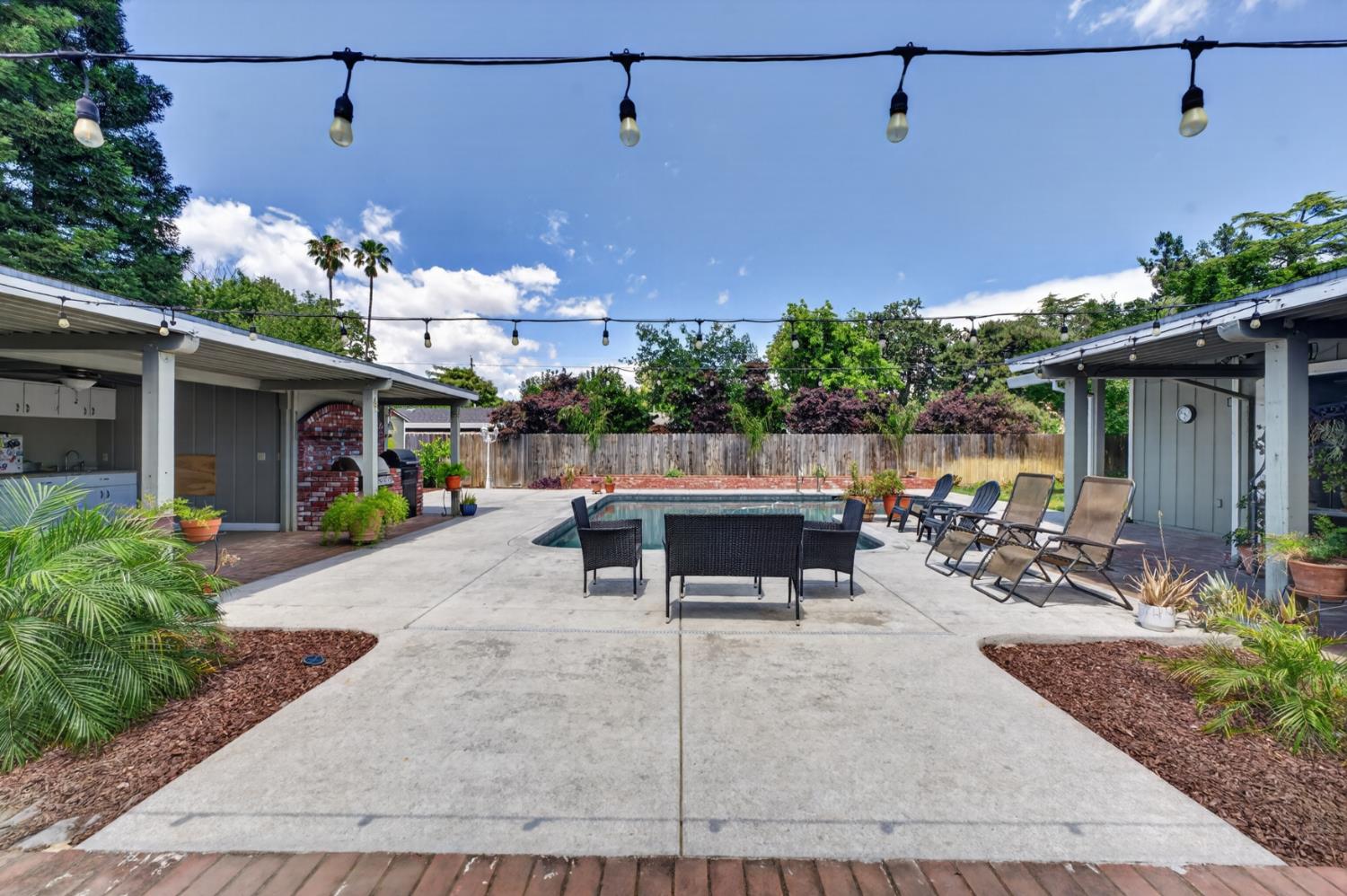 1880 Magnolia Street Gridley, CA 95948 - Photo 51 of 95 a view of a patio with table and chairs potted plants and floor to ceiling window