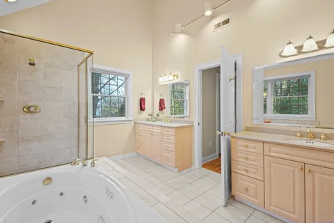 a bathroom with a sink vanity tub and shower