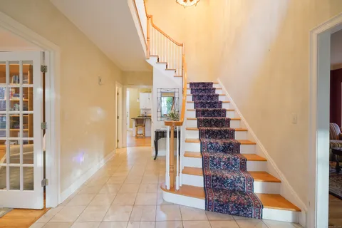 a view of a hallway with wooden floor and entryway