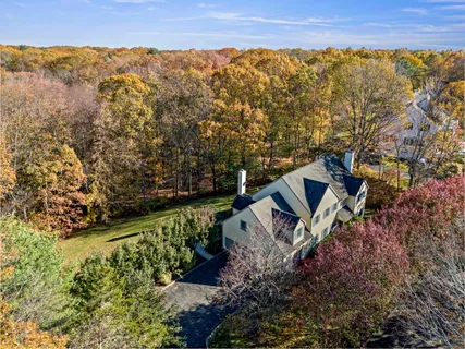a view of a yard with wooden fence