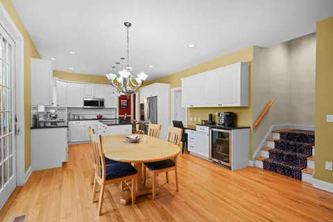 a large kitchen with a table and chairs