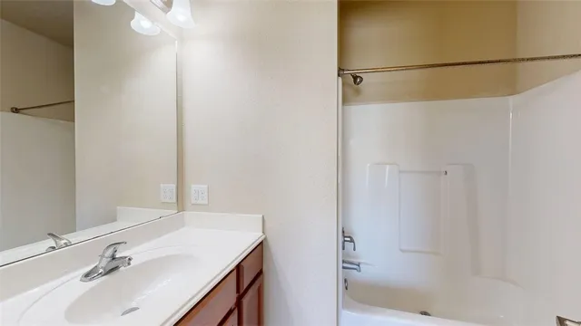 a bathroom with a sink and shower