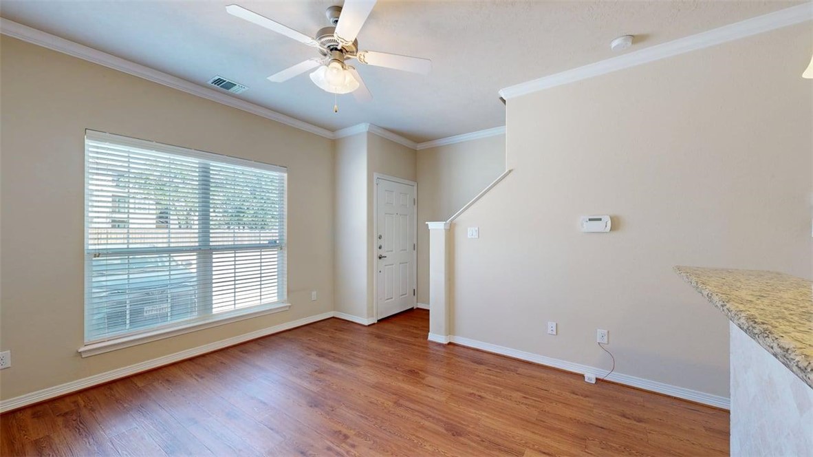 1198 Jones-Butler Road, Unit 2603 College Station, TX 77840 - Photo 3 of 29 a view of an empty room with wooden floor and a window