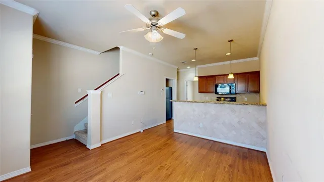a view of kitchen and hall with wooden floor