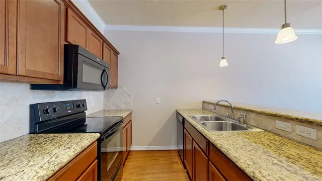 a kitchen with sink cabinets and stove top oven