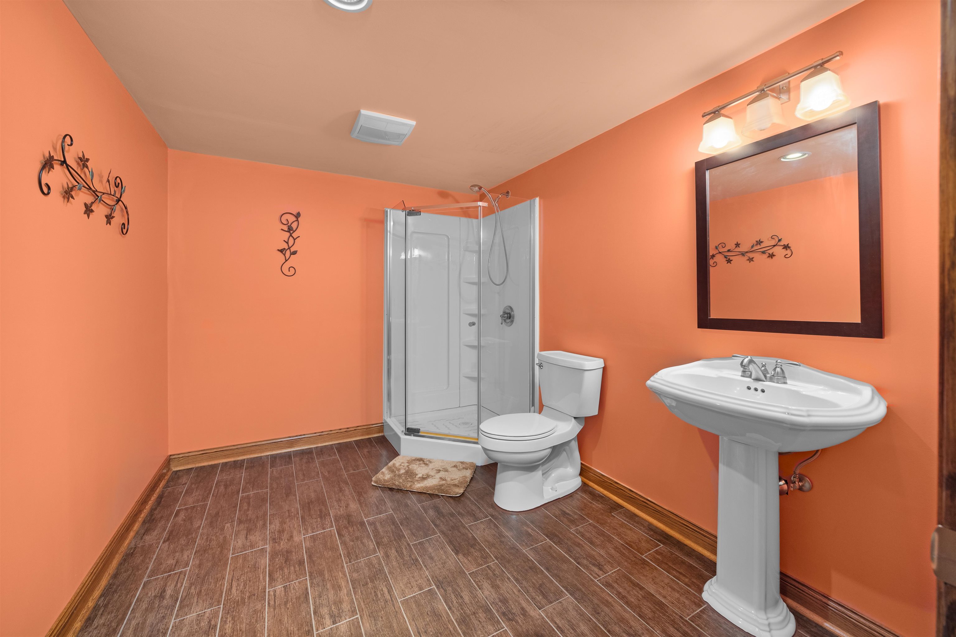 306 Winding Trail Genoa, IL 60135 - Photo 23 of 25 a bathroom with a toilet a sink and mirror