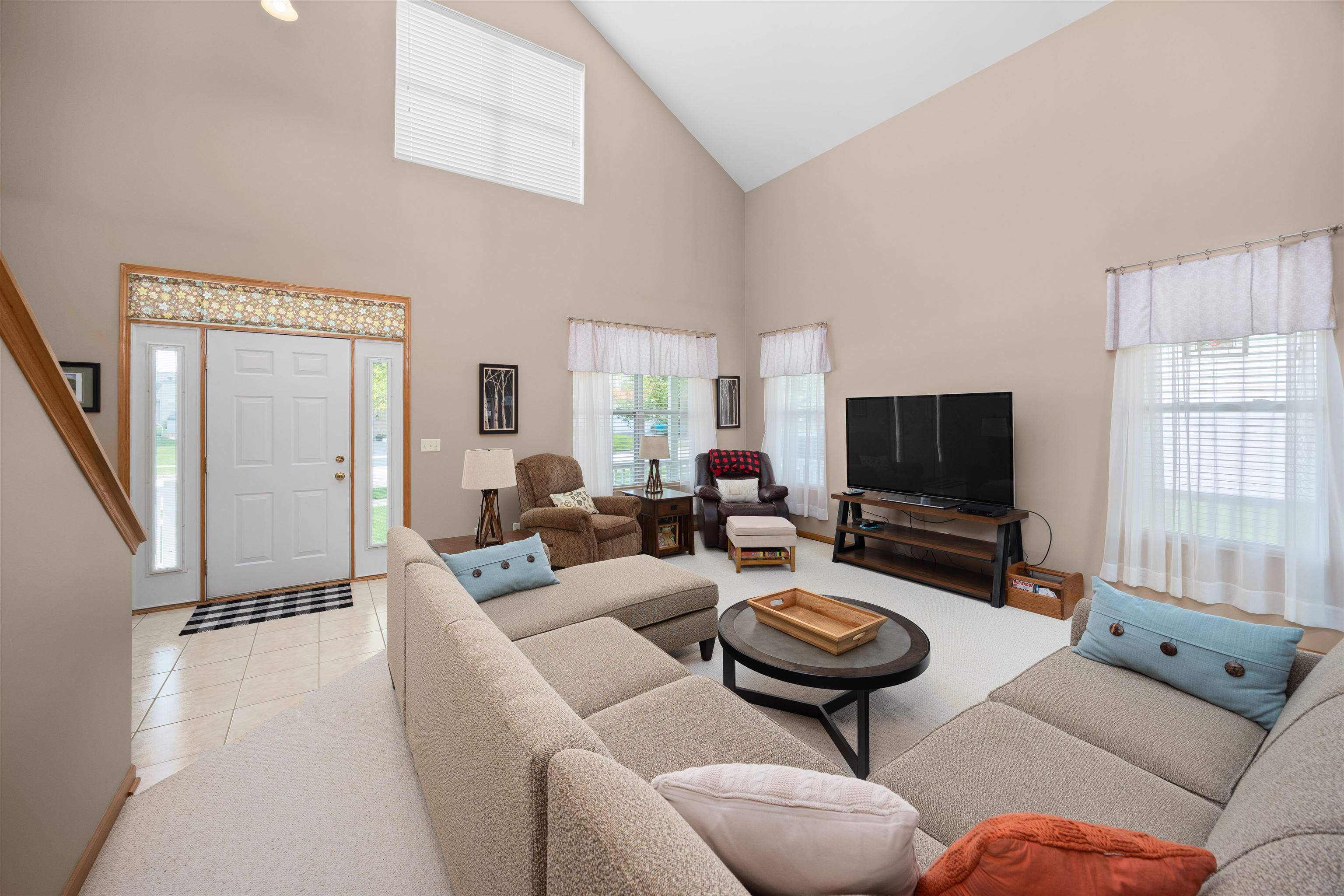 306 Winding Trail Genoa, IL 60135 - Photo 4 of 25 a living room with furniture a flat screen tv and a large window