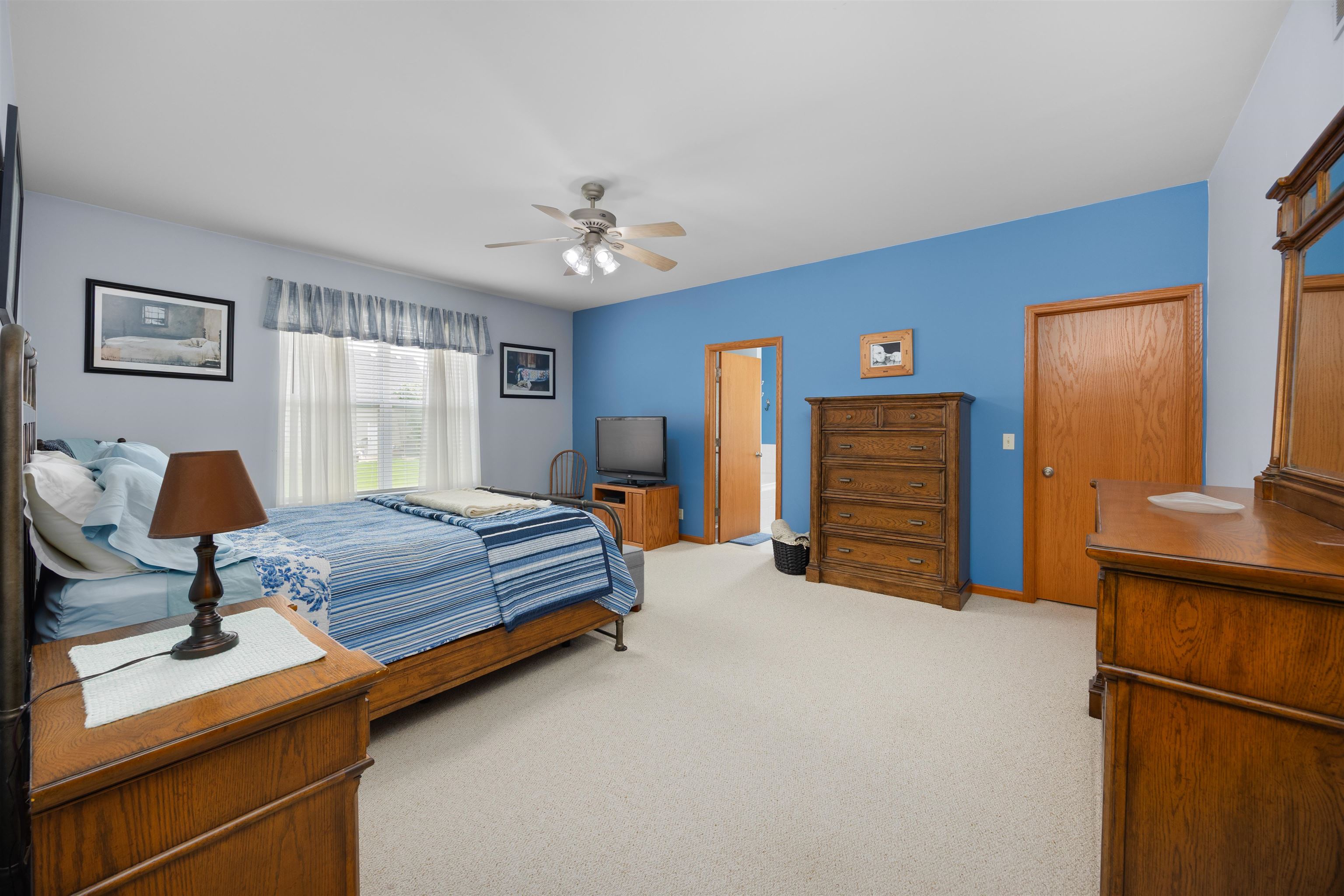 306 Winding Trail Genoa, IL 60135 - Photo 10 of 25 a bedroom with a bed and a chandelier