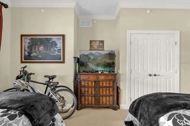 a bedroom with a bed and a chandelier