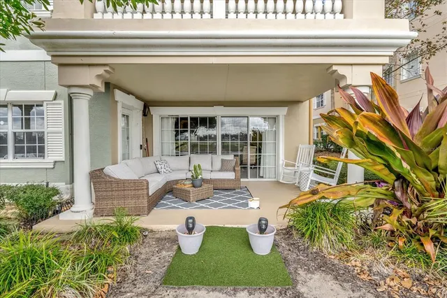 a view of a house with swimming pool and sitting area