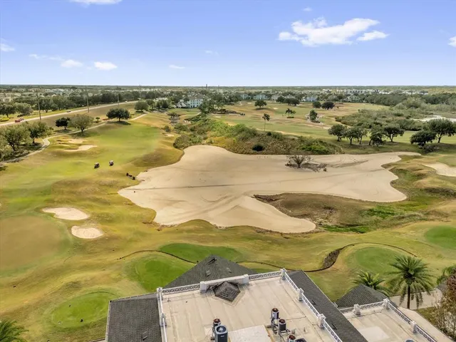 an aerial view of multiple houses with yard