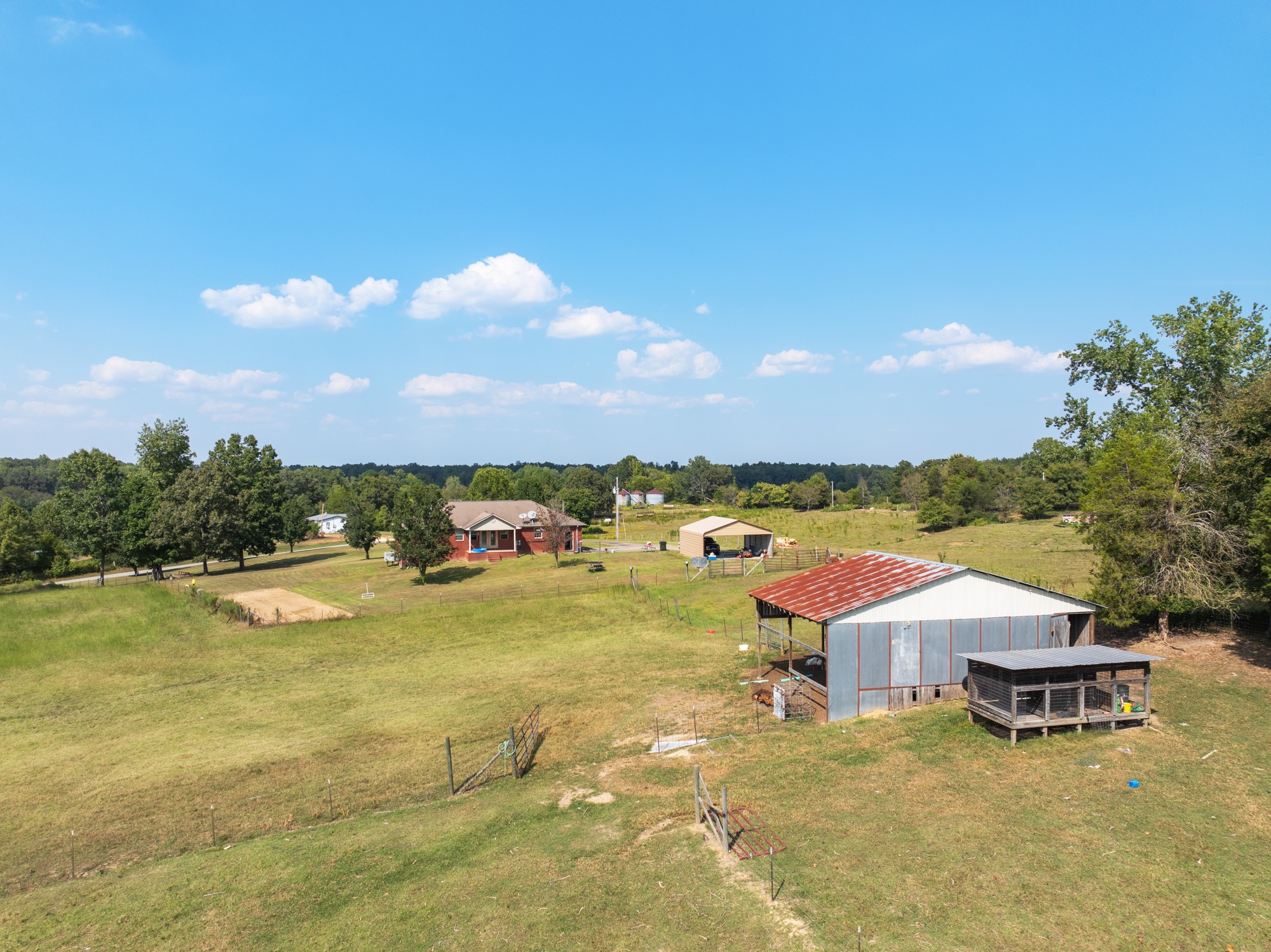 1354 Brandon Road Huntingdon, TN 38344 - Photo 18 of 37 a view of a lake with lawn chairs and large trees