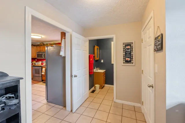 a view of a hallway with bathroom and a sink
