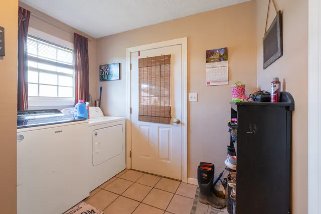 a large kitchen with a table and chairs